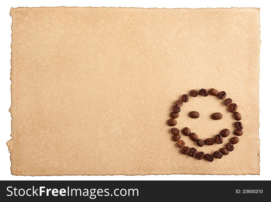 Childish smiley face symbol made from coffee crops on hand-made paper and isolated on white. Place for text. Childish smiley face symbol made from coffee crops on hand-made paper and isolated on white. Place for text.