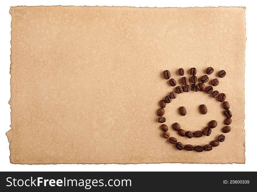 Childish smiley face symbol made from coffee crops on hand-made paper and isolated on white. Place for text. Childish smiley face symbol made from coffee crops on hand-made paper and isolated on white. Place for text.