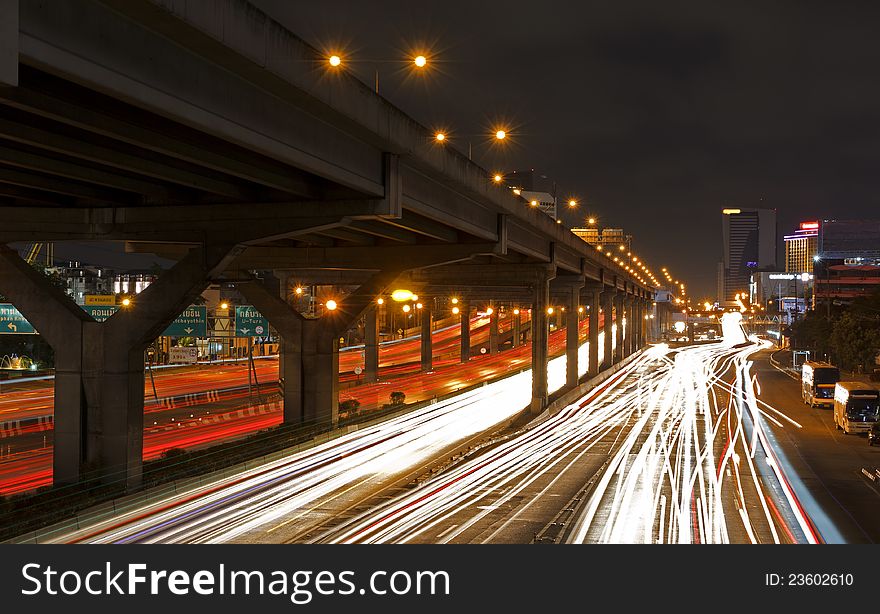 Lights on at night. In the city the car is running. Lights on at night. In the city the car is running.