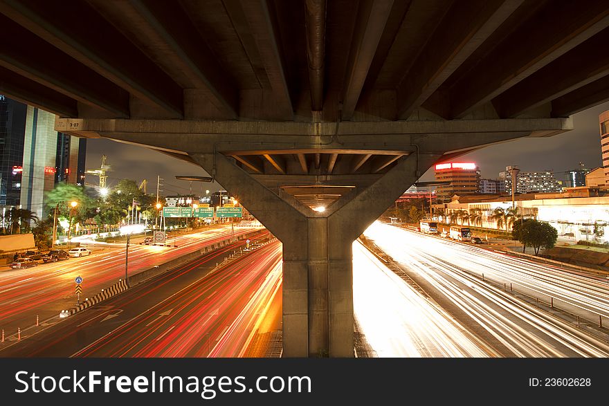 Lights on at night. In the city the car is running. Lights on at night. In the city the car is running.