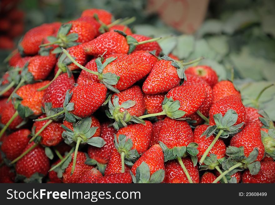 A pile of fresh red strawberries in Bangkok morning market.
