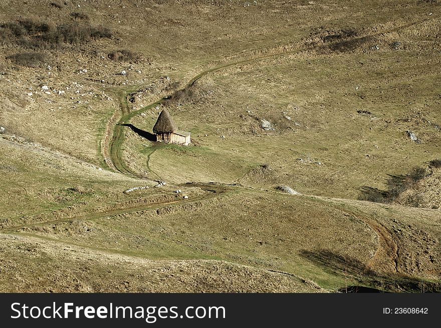 A small barn in the middle of the meadow