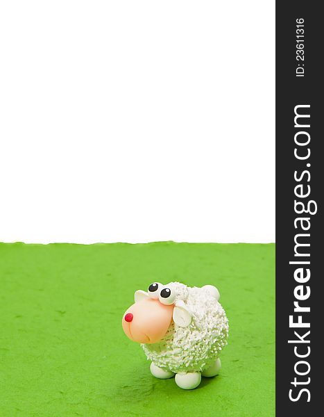 White sheep on fake green grass look up blank area isolated on green background. White sheep on fake green grass look up blank area isolated on green background