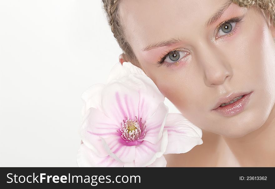 Portrait of beautiful young woman with lily flower. Isolated on white background