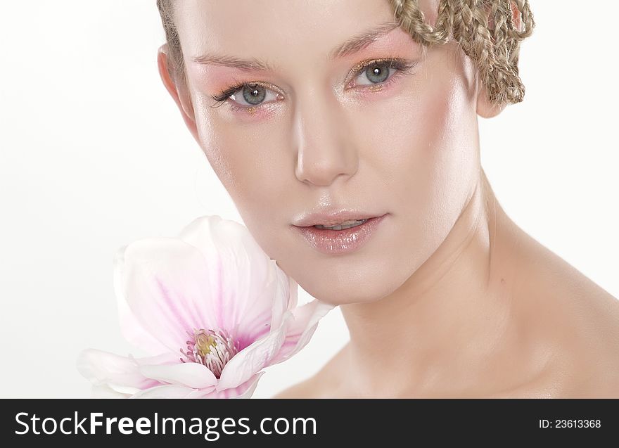 Portrait of beautiful young woman with lily flower. Isolated on white background