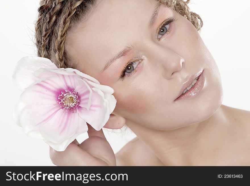 Portrait of beautiful young woman with lily flower. Isolated on white background