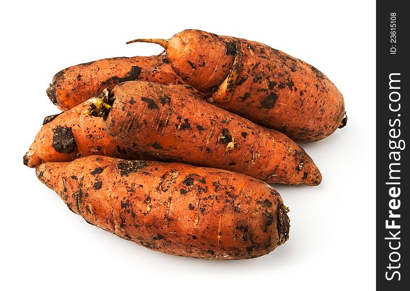 Muddy carrot heap against white background