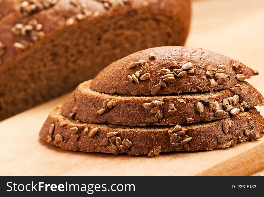 Brown bread slices on a wooden board