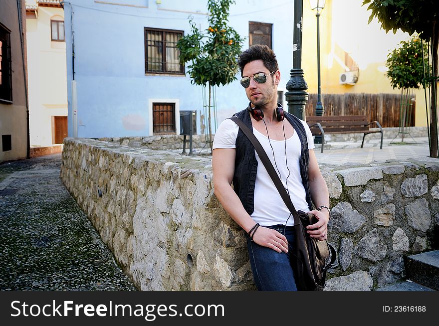 Portrait of young attractive man in urban background. Portrait of young attractive man in urban background