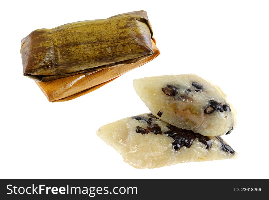 Thai snack :  Sticky rice with black beans and banana, steamed in banana leaf  (khaotom mat) isolated on white