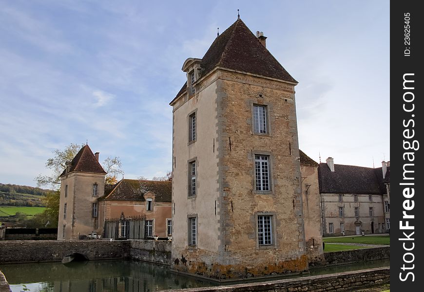 The chateau de Commarin (castle) is located in Burgundy, France. The castle is moated, surrounded by water.