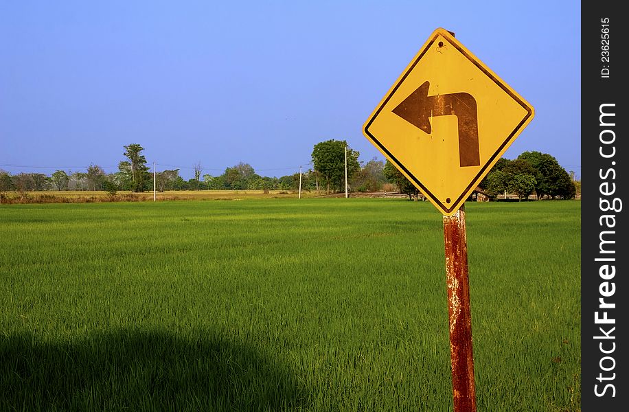 Rice field with turn left sign in countryside. Rice field with turn left sign in countryside