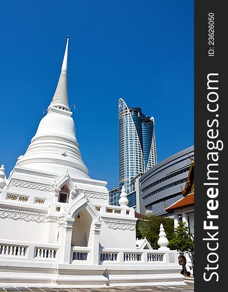 Pagoda in famous temple located in the center of Bangkok business area versus modern shopping building. Pagoda in famous temple located in the center of Bangkok business area versus modern shopping building