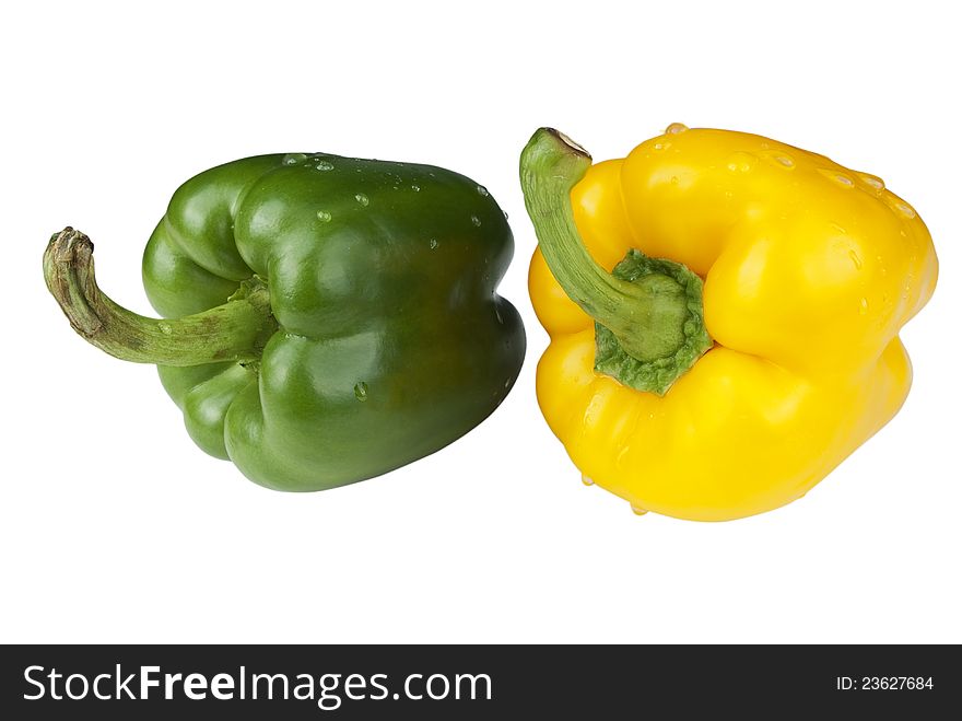 Green and yellow paprica with droplet on a white background