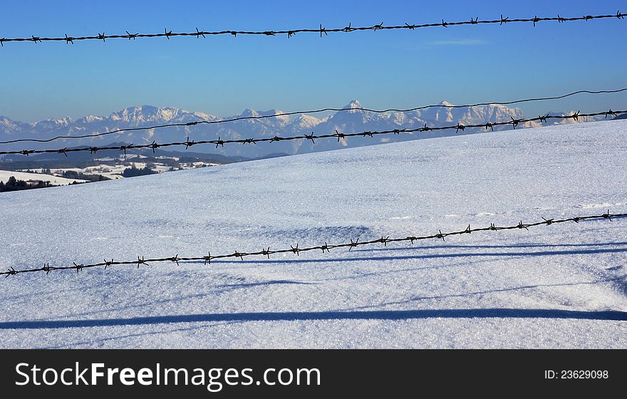 The allgÃ¤uer Alps behind the fence. The allgÃ¤uer Alps behind the fence