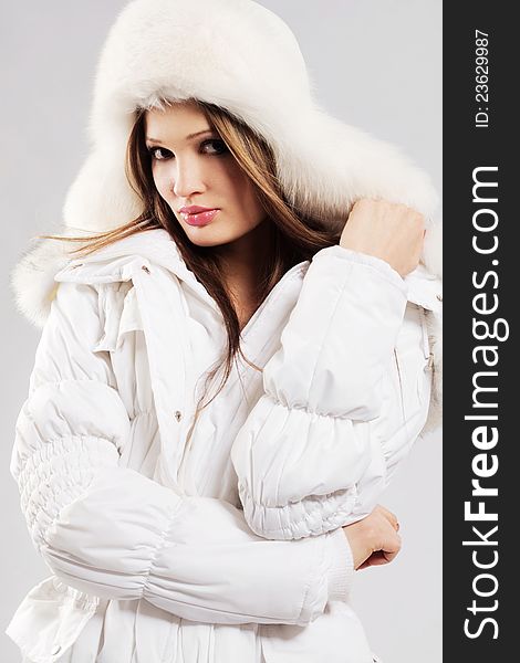 Beautiful woman in white winter clothing