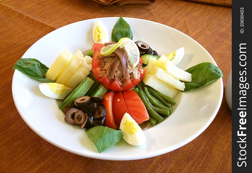 Tuna salad healthy fresh vegetable, Tomato, egg, olive, potato's on a plate. Tuna salad healthy fresh vegetable, Tomato, egg, olive, potato's on a plate