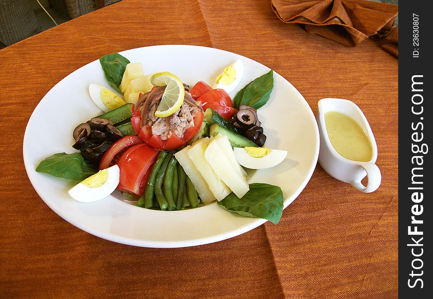 Tuna salad healthy fresh vegetable, Tomato, egg, olive, potato's  on a plate. Tuna salad healthy fresh vegetable, Tomato, egg, olive, potato's  on a plate