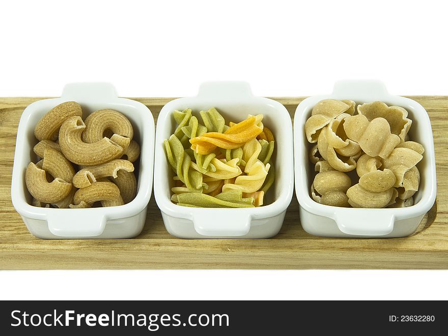 Three sorts of uncooked pasta in a ceramic dishes. Three sorts of uncooked pasta in a ceramic dishes