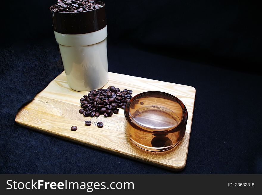 Coffee beans and a grinder on a wooden tray. Coffee beans and a grinder on a wooden tray