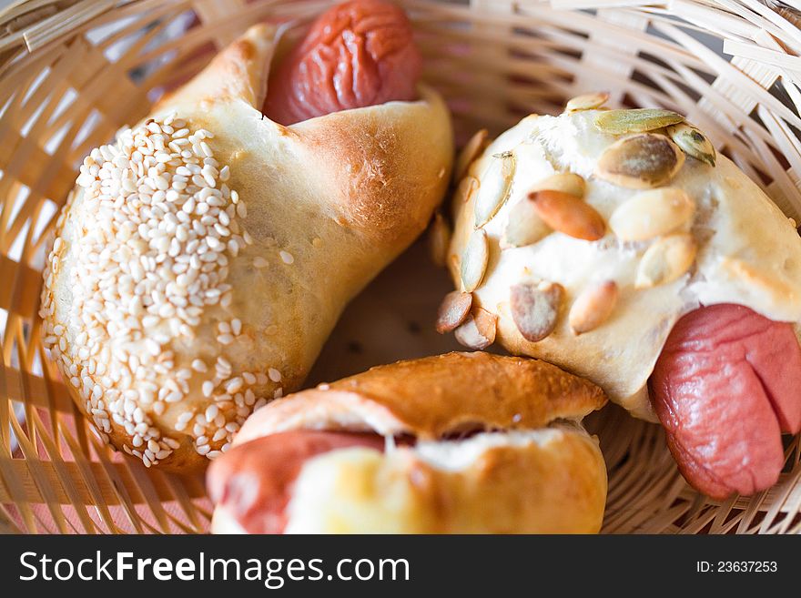 Three buns with seeds on wood plate. Three buns with seeds on wood plate