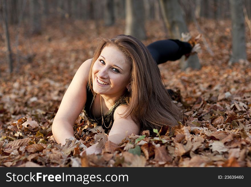 Girl on a background of brown leaf. Girl on a background of brown leaf
