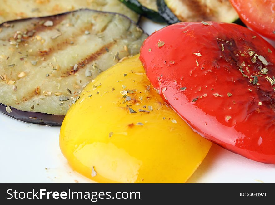 Close up grilled vegetables of different colors on a white background. Close up grilled vegetables of different colors on a white background