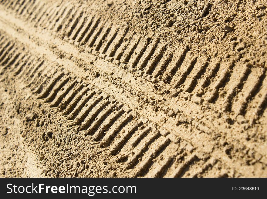 Tire tracks in the sand left by a car. Tire tracks in the sand left by a car
