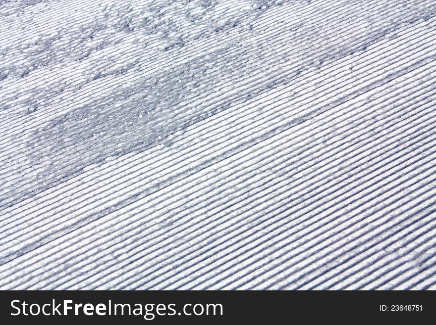 Grooves of artificial aligned snow on the ski slope. Grooves of artificial aligned snow on the ski slope