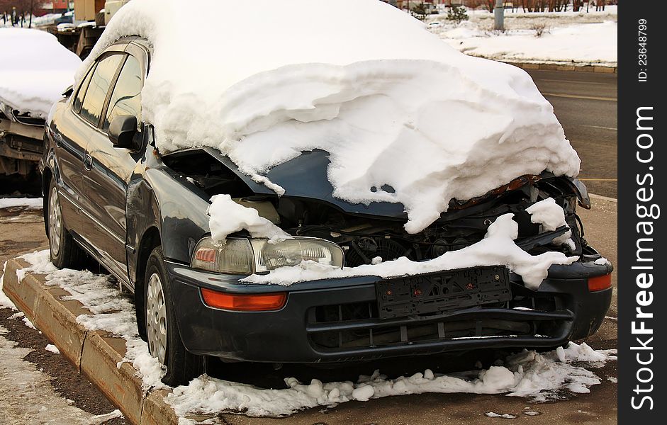 Car after accident left by it's owner and is in the weather covered with snow. Car after accident left by it's owner and is in the weather covered with snow