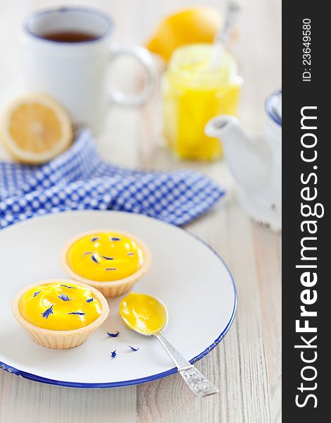 Tartlets with lemon curd and dried cornflower petals, selective focus. Tartlets with lemon curd and dried cornflower petals, selective focus