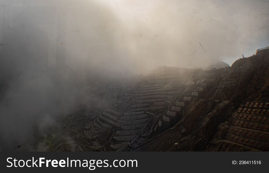 Egg-producing factory covered by sulphuric smoke in volcanic valley in Japan.