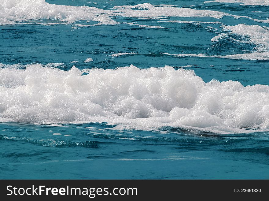 White foam on a sea water surface. White foam on a sea water surface