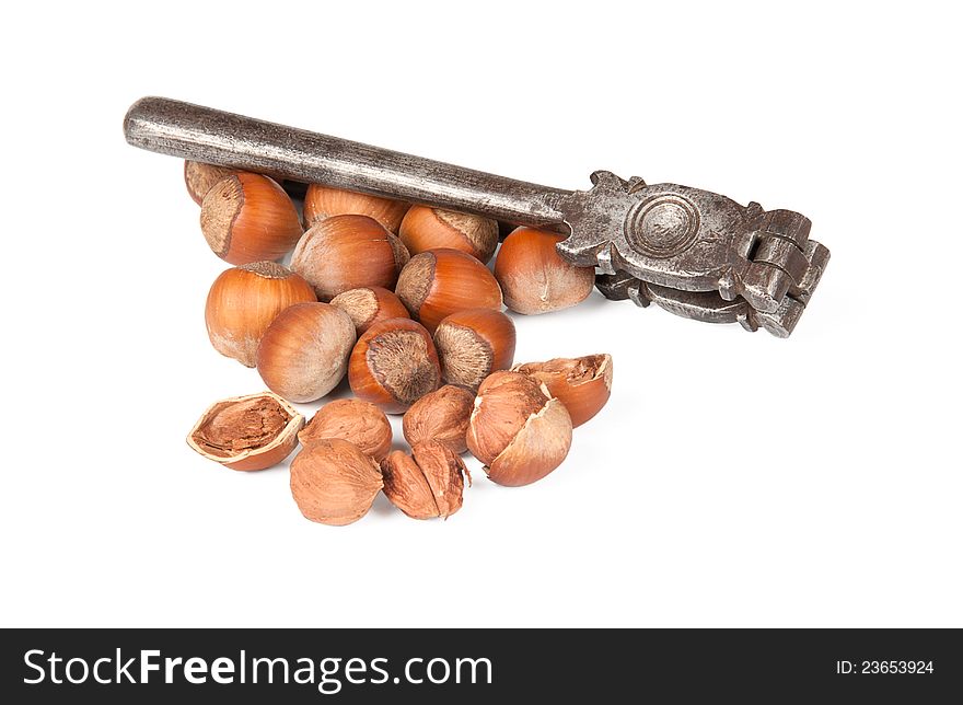 Nutcracker and cracked nuts on white background. Nutcracker and cracked nuts on white background