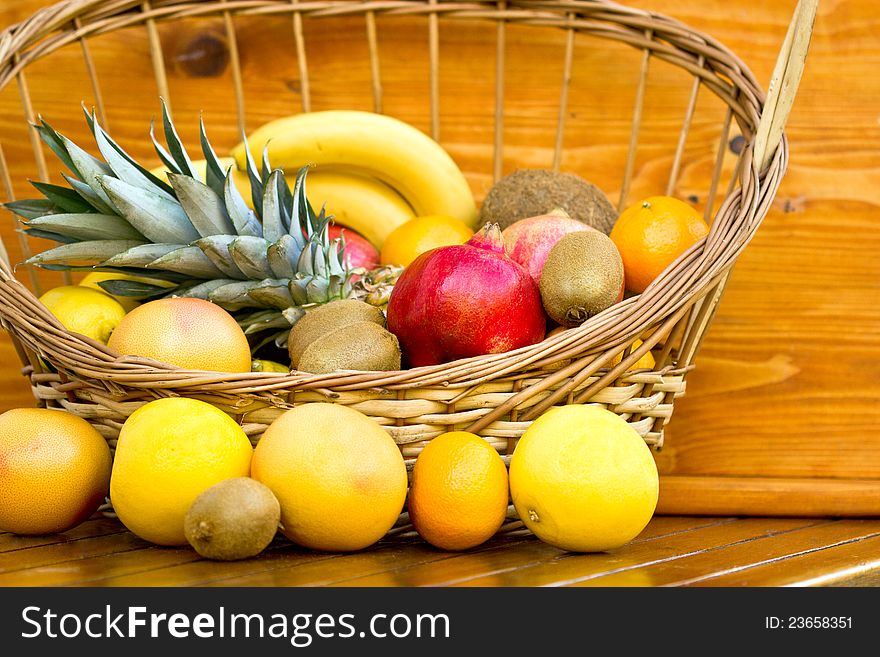 Tropical fruits in the wicker basket on the table
