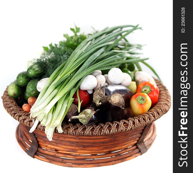 Basket of fresh vegetables isolated on white. Basket of fresh vegetables isolated on white