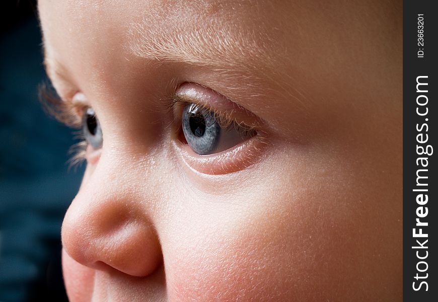 Baby Face with piercing blue eyes in profile. Baby Face with piercing blue eyes in profile