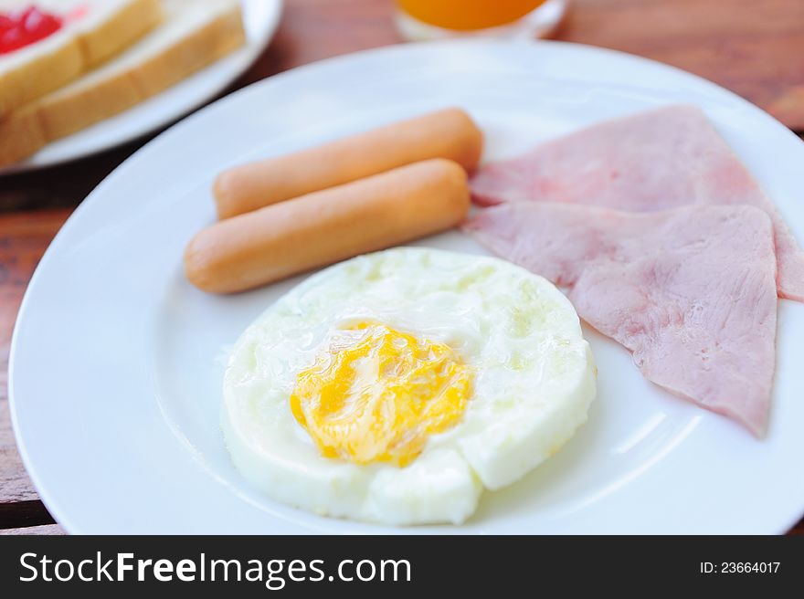 Breakfast with egg, sausage, and ham