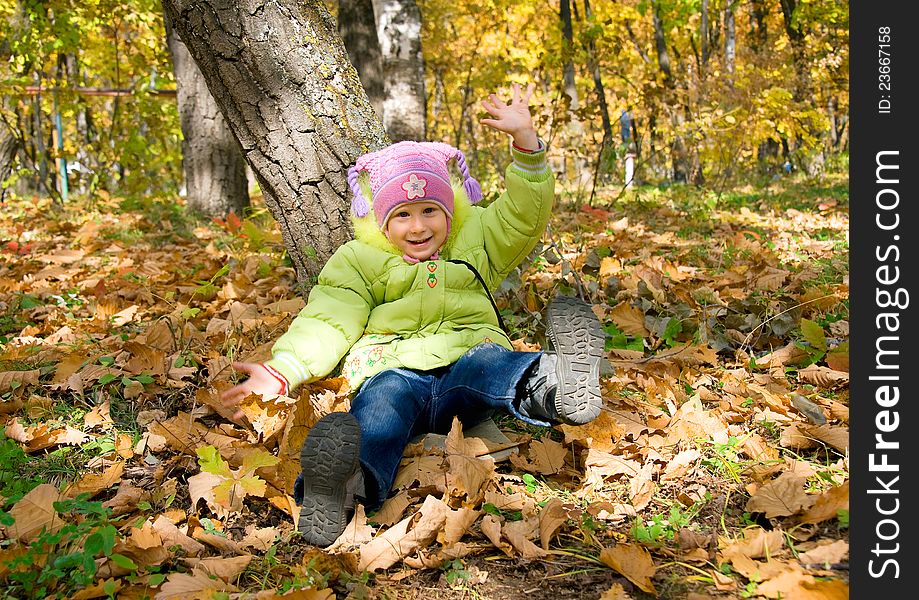 Girl sits under tree in autumn park. Girl sits under tree in autumn park