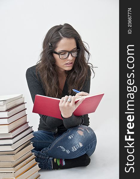 Student girl learning photographed with books, white background