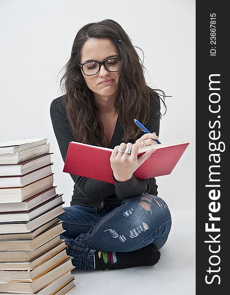 Student girl learning photographed with books, white background