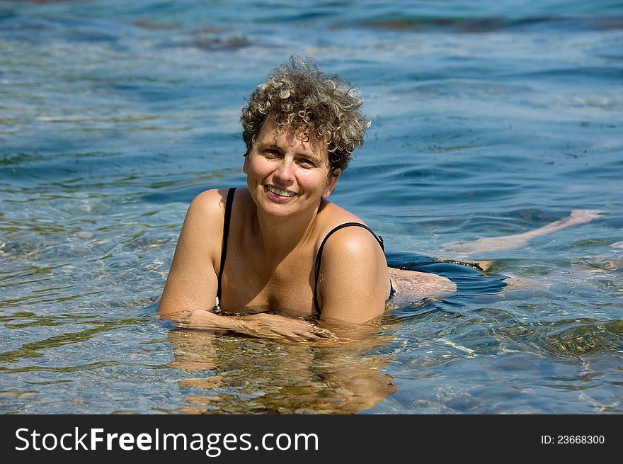 Portrait of a woman lying in the surf. Portrait of a woman lying in the surf
