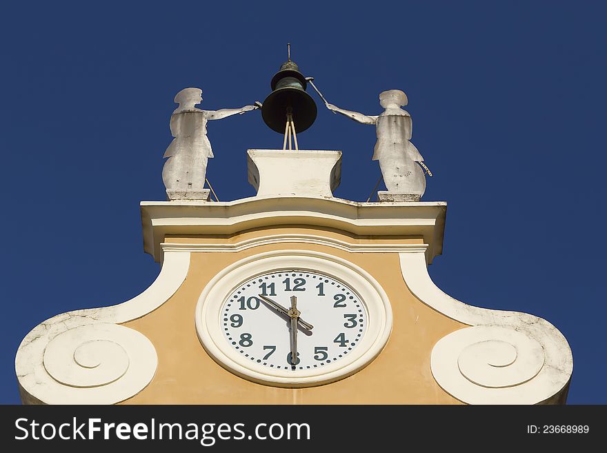 Clock Tower at Town Hall. Above the clock's bell and figures of two craftsmen. (Bardolino, Lake Garda, Italy). Clock Tower at Town Hall. Above the clock's bell and figures of two craftsmen. (Bardolino, Lake Garda, Italy)