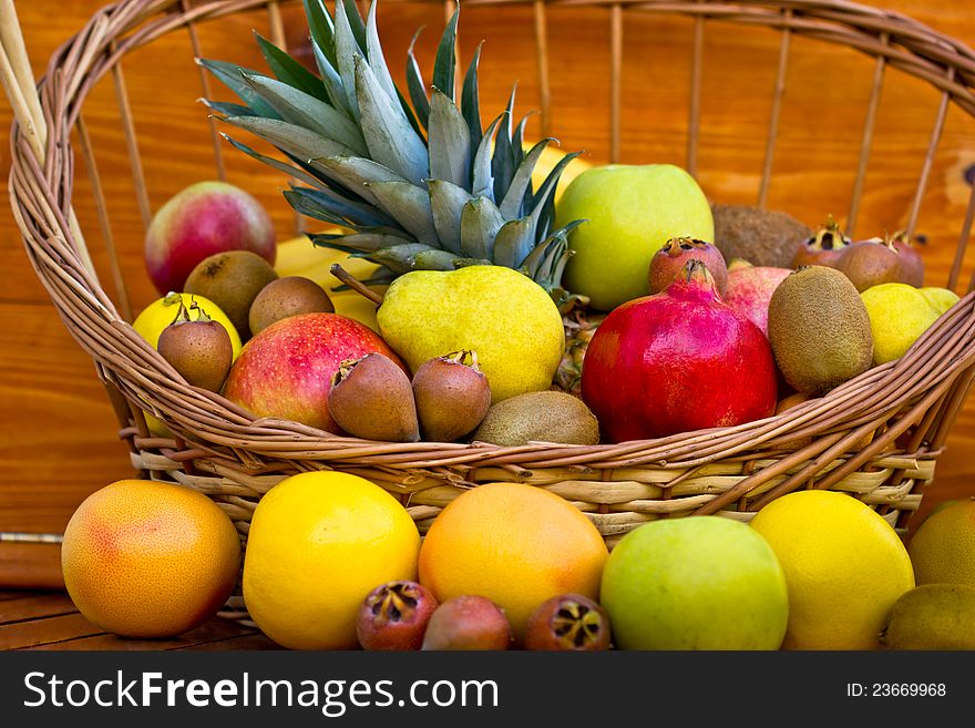 European fruits and tropical fruits in the wicker basket on the table