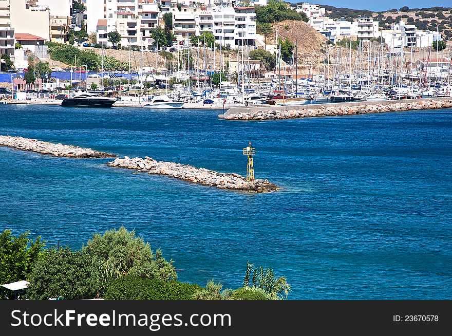 A small town on the sun-lit beach. In its harbor is a lot of yachts and boats. Today is a good day and they will come out into the sea. A small town on the sun-lit beach. In its harbor is a lot of yachts and boats. Today is a good day and they will come out into the sea.