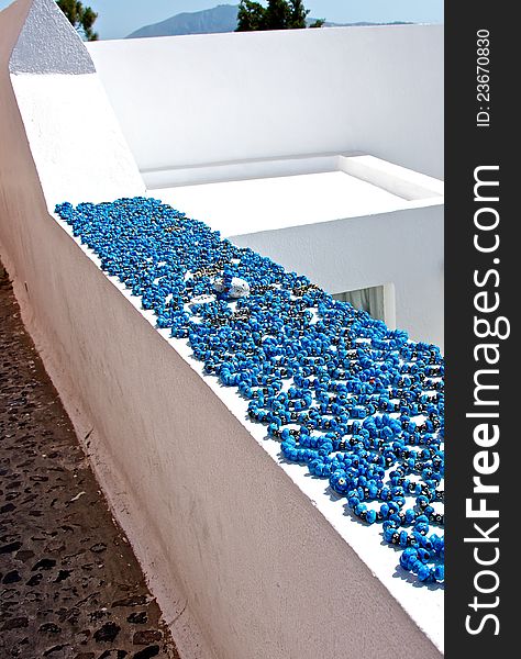 Jewelry made of turquoise, on Santorini are sold at every step, a very impressive-looking on the white stones and the walls of the city. Jewelry made of turquoise, on Santorini are sold at every step, a very impressive-looking on the white stones and the walls of the city.