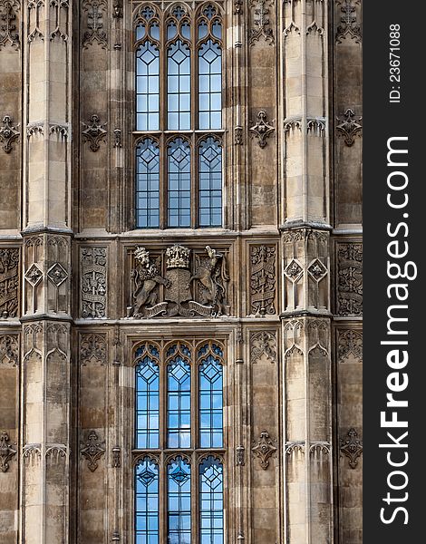 Building facade with windows and carvings, part of the House of Parliament in London. Building facade with windows and carvings, part of the House of Parliament in London.