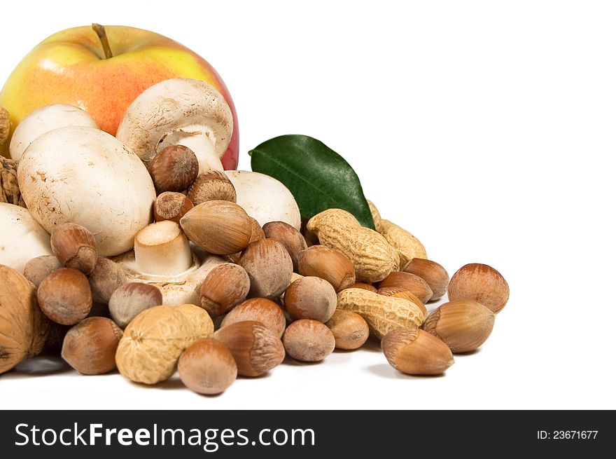 Apple, nuts and mushrooms on a white background