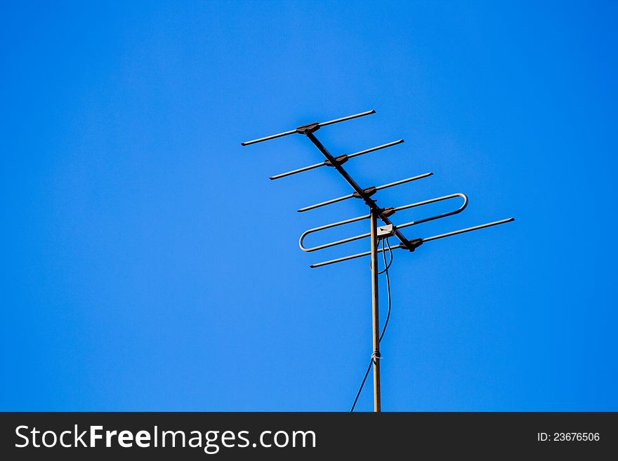 Home television antenna in a blue sky background. Home television antenna in a blue sky background