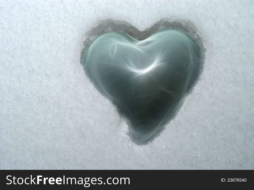 Fragile glass heart embedded in ice cold snow. Fragile glass heart embedded in ice cold snow